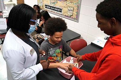 Middle School students with instructor in first aid calss.